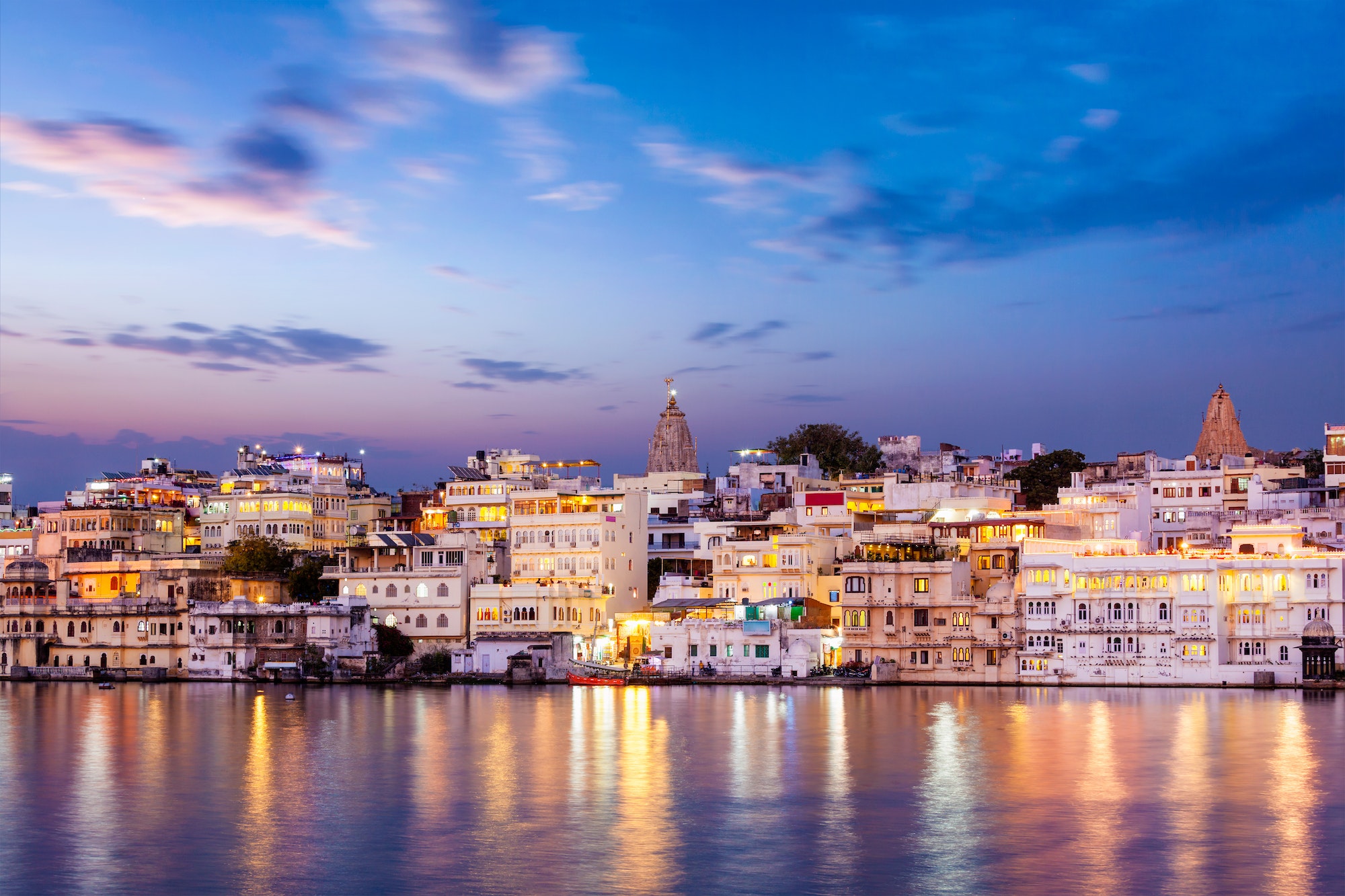 Evening view of illuminated houses on lake Pichola in Udaipur
